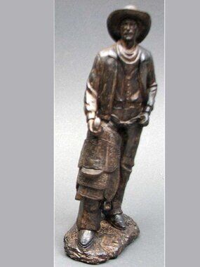 Stone Resin (Bronze looking) Cowboy with his Saddle Statue 12 1/2" tall 14122
